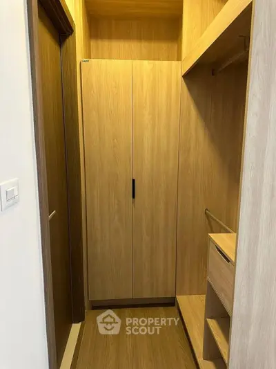 Spacious walk-in closet with wooden finish and ample storage space.