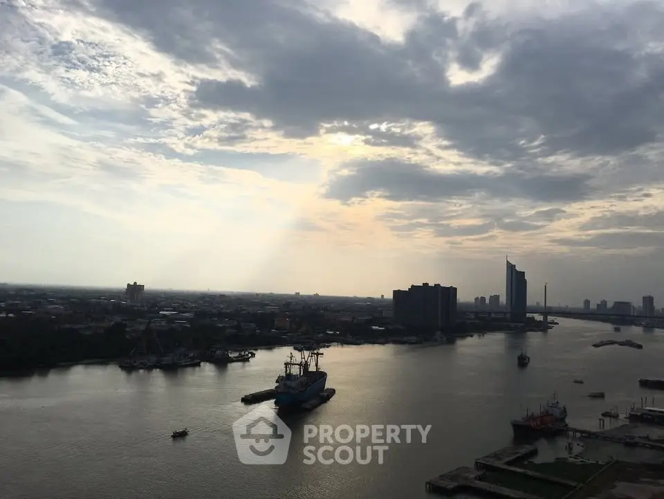 Stunning river view with city skyline and dramatic sky, perfect for urban living enthusiasts.