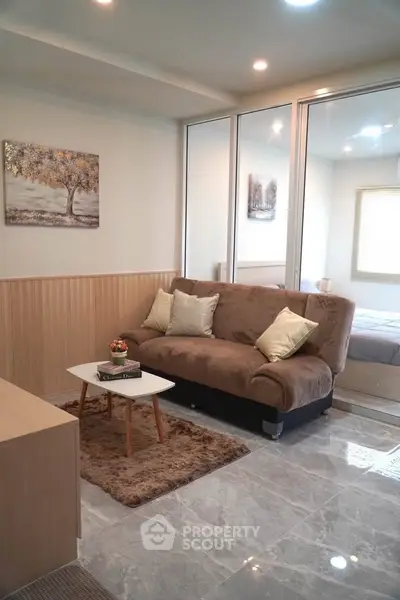 Modern living room with cozy sofa and elegant decor in stylish apartment.