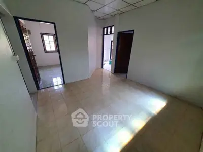 Spacious room with tiled flooring and natural light, ideal for versatile use.