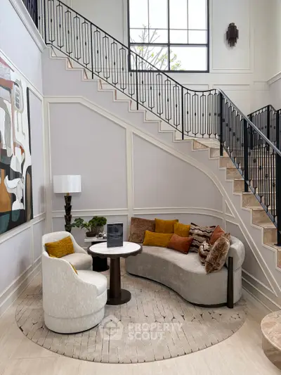 Elegant living room with stylish furniture and modern staircase in luxury home