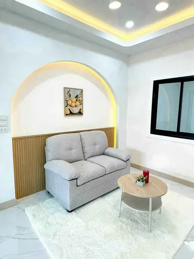Modern living room with cozy sofa and stylish decor in a bright, inviting space.
