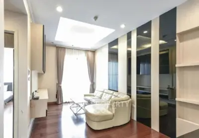 Modern living room with sleek design and natural light, featuring a cozy leather sofa and stylish decor.
