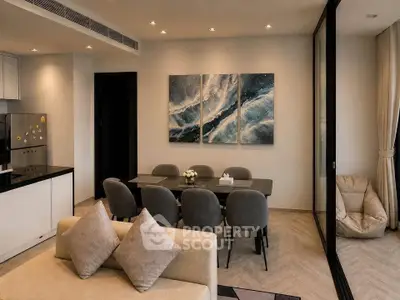 Modern open-plan living and dining area with stylish decor and natural lighting.