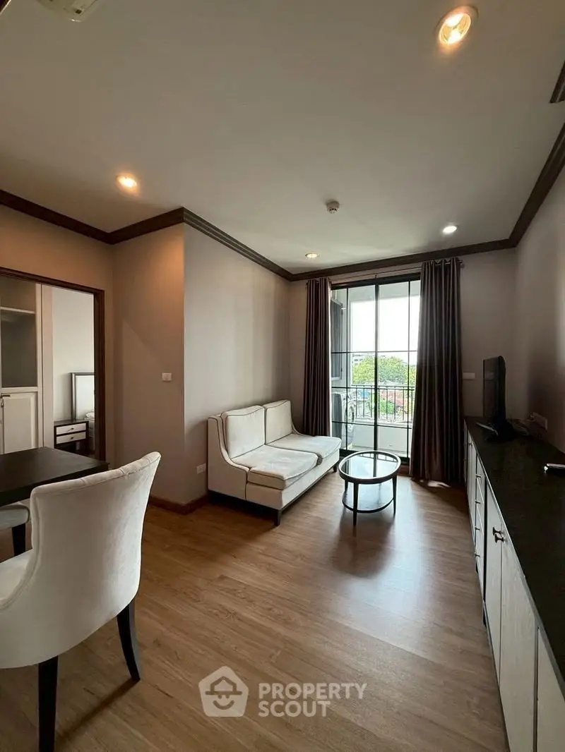Modern living room with elegant furniture and balcony view in a stylish apartment.