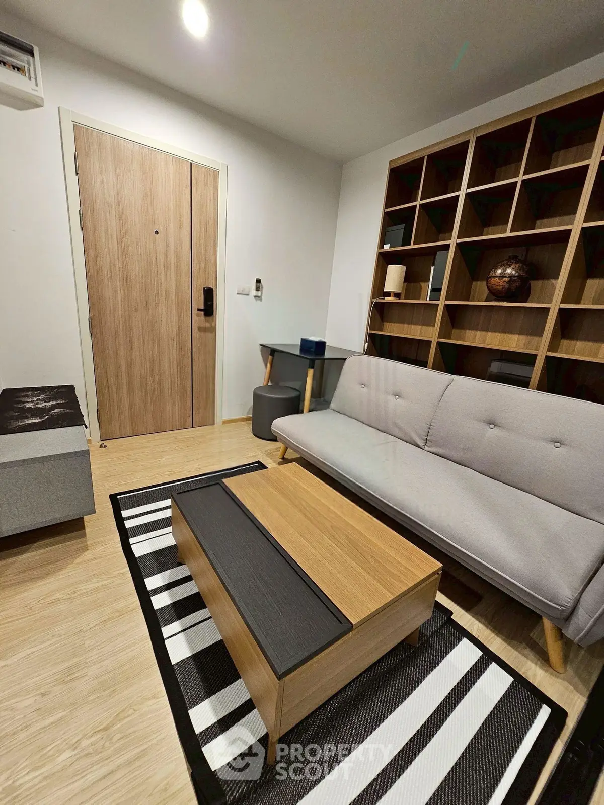 Modern living room with stylish furniture and wooden accents, perfect for cozy urban living.