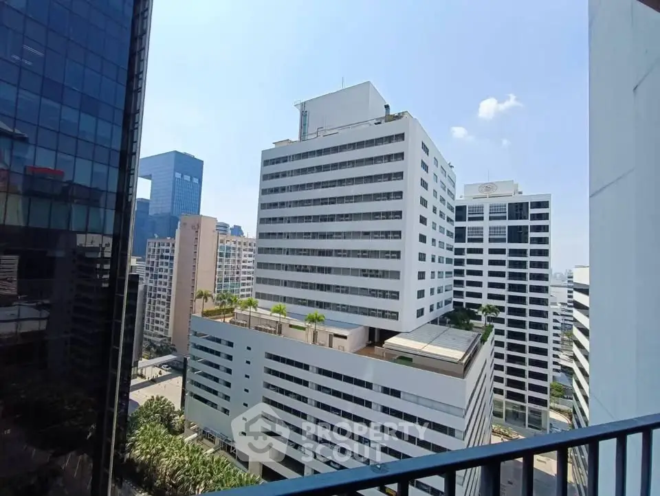 Stunning cityscape view from a high-rise balcony showcasing modern architecture and urban skyline.