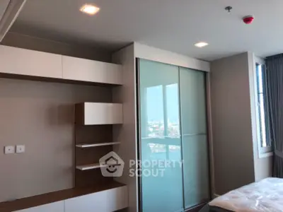 Modern bedroom with sliding closet doors and built-in shelving