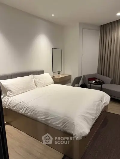Modern bedroom with cozy bed, stylish furniture, and ambient lighting for a relaxing atmosphere.