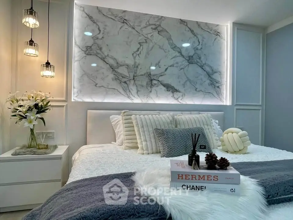 Luxurious bedroom with elegant marble accent wall and designer decor