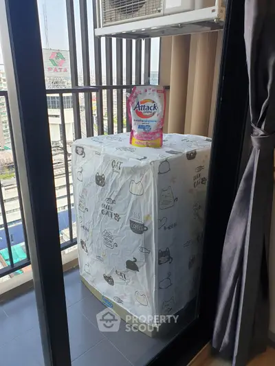 Charming balcony with city view and laundry setup, perfect for urban living.
