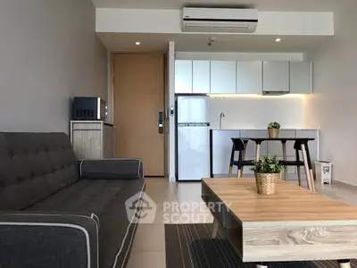 Modern living room with sleek kitchen, stylish furniture, and contemporary decor in open layout apartment.
