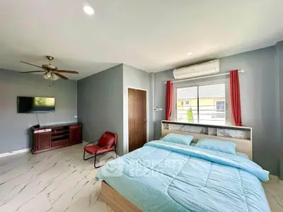 Spacious bedroom with modern decor and natural light