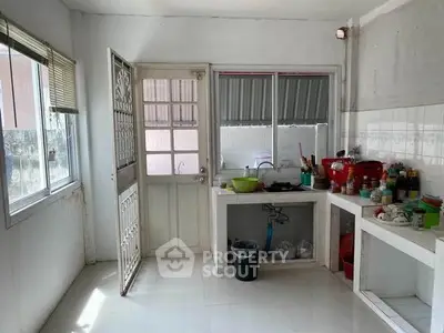 Spacious kitchen with open layout and ample natural light, featuring modern appliances and sleek countertops.