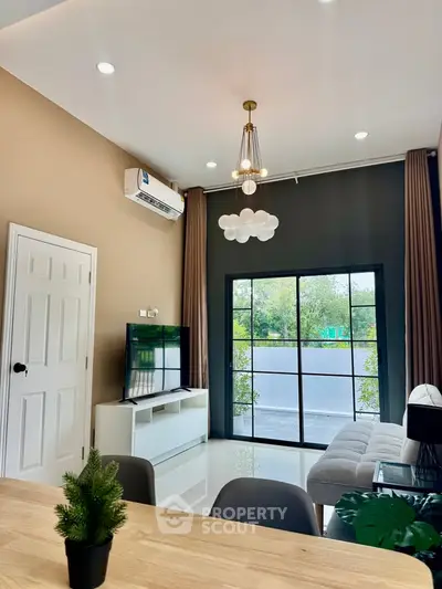 Modern living room with high ceiling and large window view