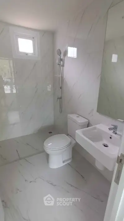 Modern bathroom with sleek marble tiles and contemporary fixtures
