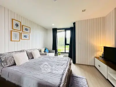 Spacious bedroom with modern decor and large window view