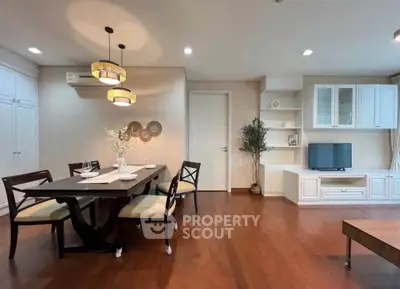 Elegant dining and living area with wooden flooring and modern decor