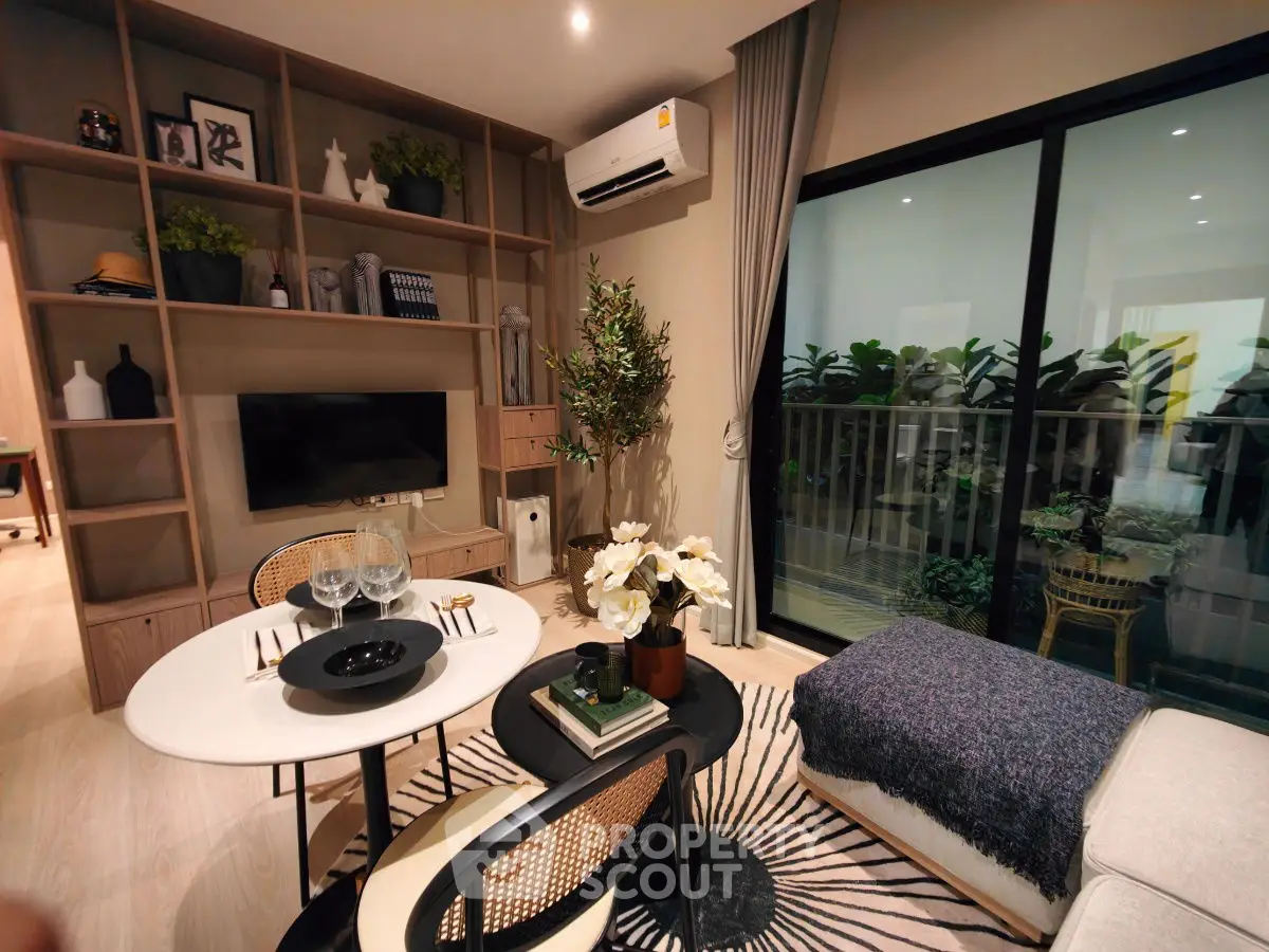 Stylish modern living room with balcony, cozy decor, and elegant dining setup.