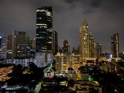 Stunning city skyline view with illuminated skyscrapers at night, showcasing urban living.