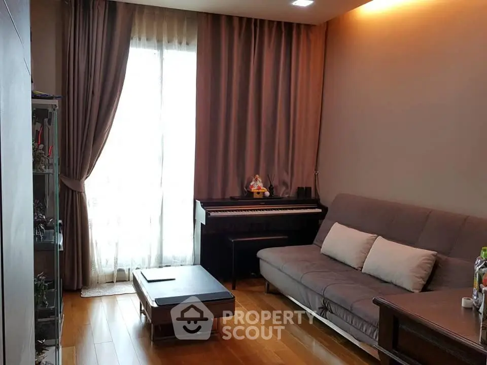 Cozy living room with piano and elegant curtains, perfect for relaxation and entertainment.