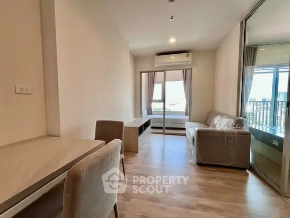 Modern living room with wooden flooring and large window view