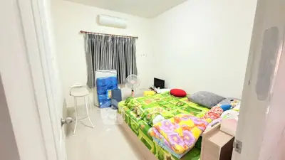 Cozy bedroom with vibrant bedding and air conditioning, perfect for restful nights.