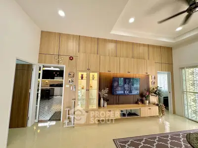 Spacious living room with modern wooden cabinetry and elegant decor