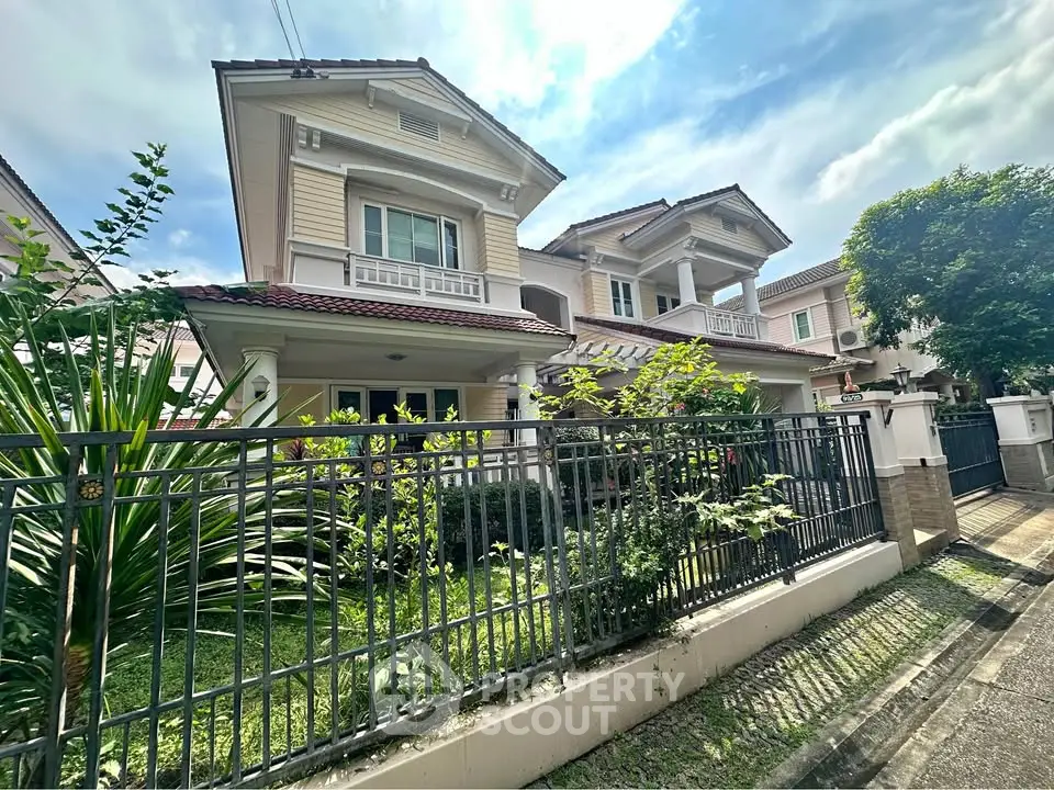 Charming two-story house with lush garden and elegant facade in a serene neighborhood.