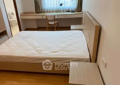 Spacious bedroom with modern wooden furniture and natural light
