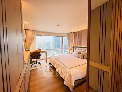 Luxurious bedroom with stunning city view, featuring elegant decor and ample natural light.