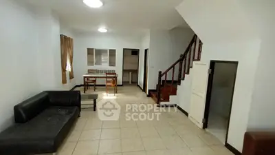 Spacious living room with staircase and dining area in modern home
