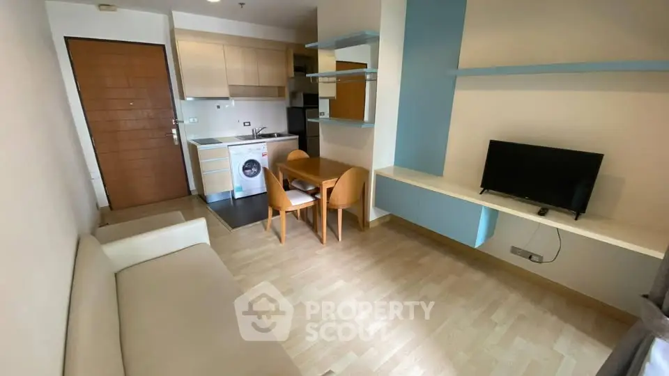 Modern apartment interior with compact kitchen and cozy living area