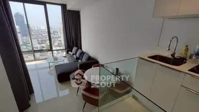 Modern apartment with open kitchen and stunning city view from large windows.