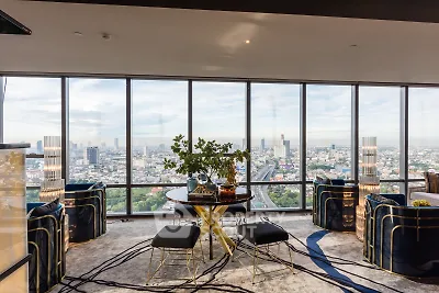 Luxurious high-rise living room with panoramic city views and modern decor.