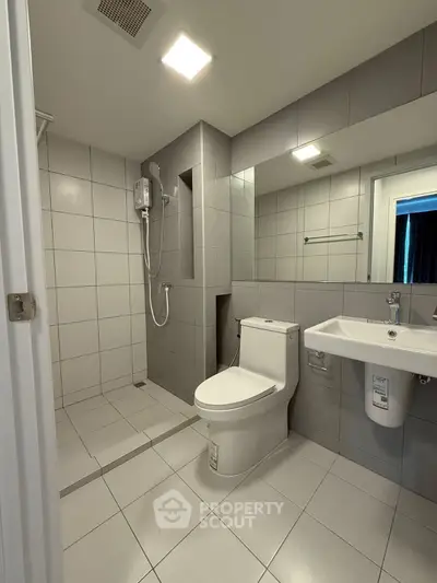 Modern bathroom with sleek tiles and contemporary fixtures