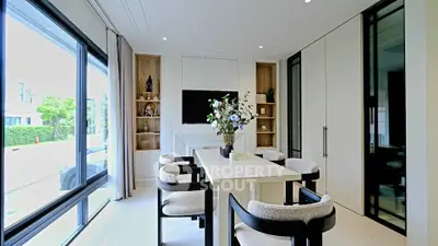 Elegant dining room with modern decor and large windows offering natural light.