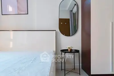 Modern bedroom with stylish mirror and minimalistic decor