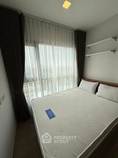 Modern bedroom with large window and elegant curtains