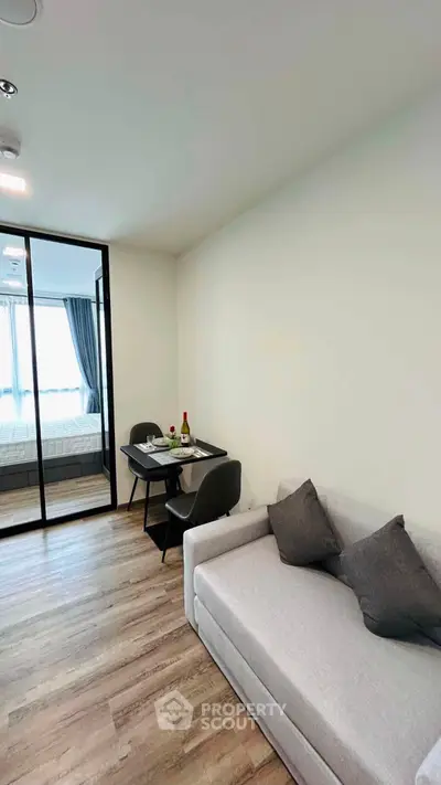 Modern living room with cozy sofa and dining area in stylish apartment