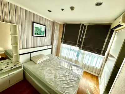 Cozy bedroom with modern decor and ample natural light, featuring a comfortable bed and stylish furnishings.