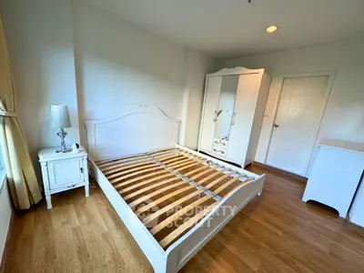 Spacious bedroom with elegant white furniture and natural light