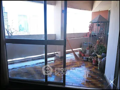 Spacious balcony with city view, perfect for urban gardening and relaxation.