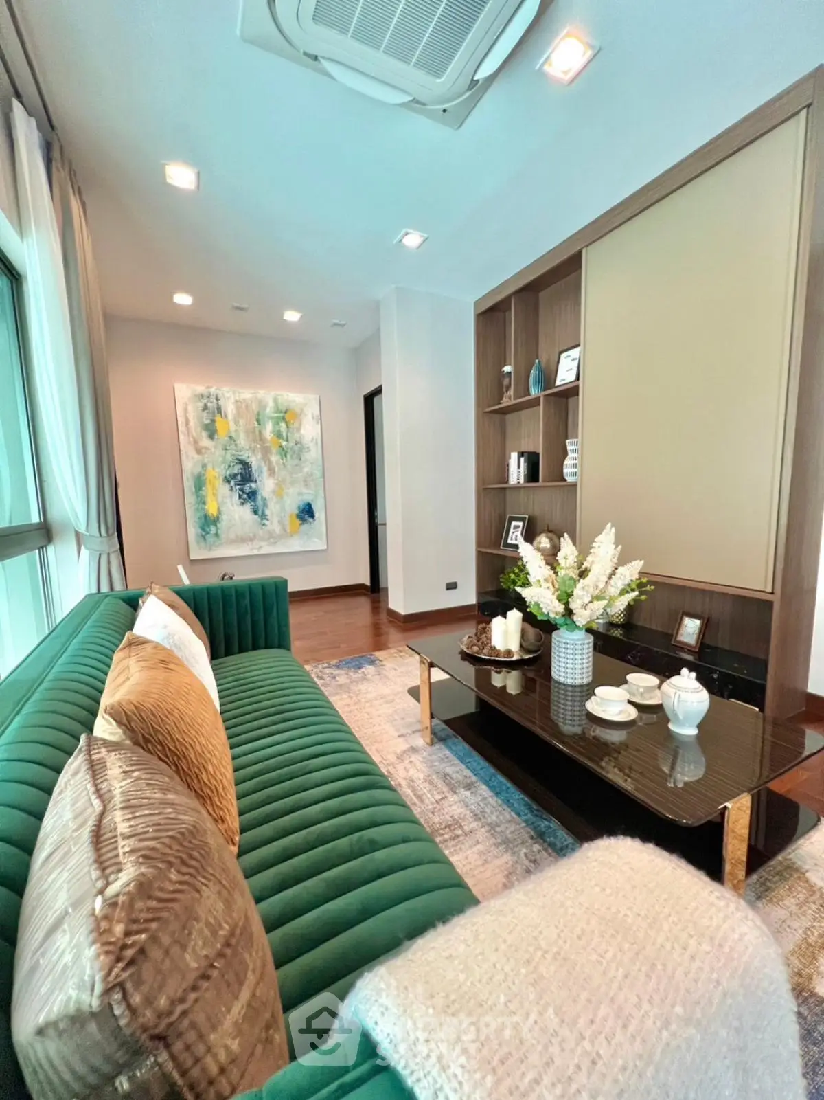 Luxurious living room with elegant decor and plush green sofa in modern apartment