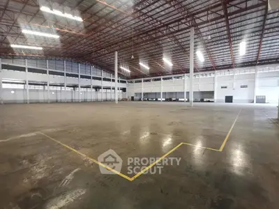 Spacious industrial warehouse with high ceilings and ample storage space.
