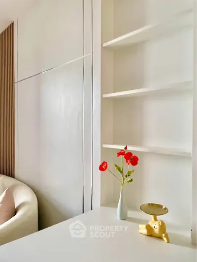 Modern minimalist living room with elegant decor and built-in shelving