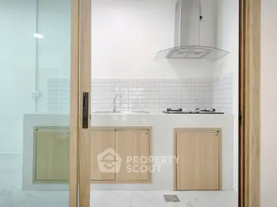 Modern kitchen with sleek cabinetry and gas stove in a contemporary apartment.