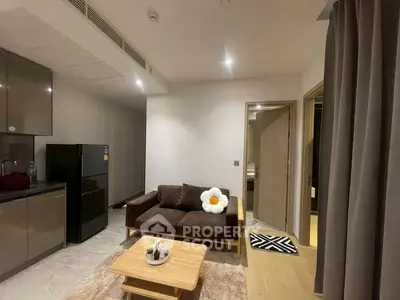 Modern living room with cozy sofa and sleek kitchen area