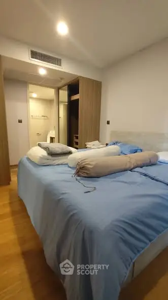 Spacious bedroom with modern decor and cozy bedding