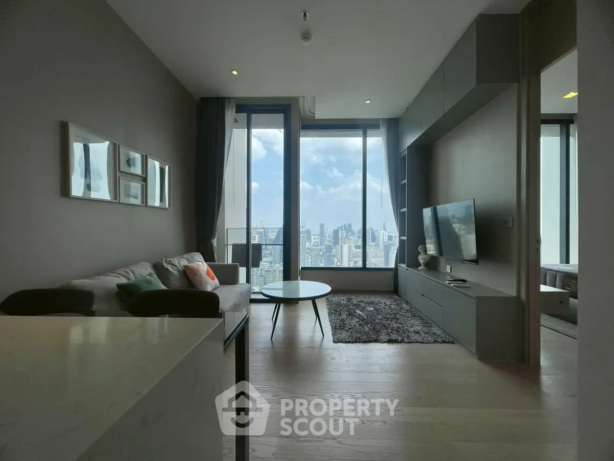 Modern living room with stunning city view, featuring sleek furniture and large windows for natural light.